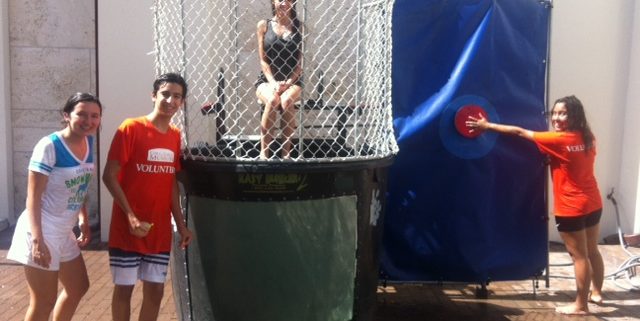 Teen volunteers have fun using the dunk tank during City Trekker Summer Camp 2014 at the Coral Gables Museum.